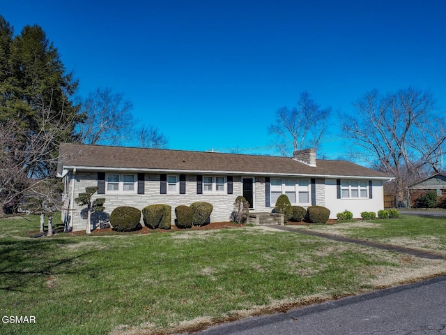 ranch-style house with a front lawn