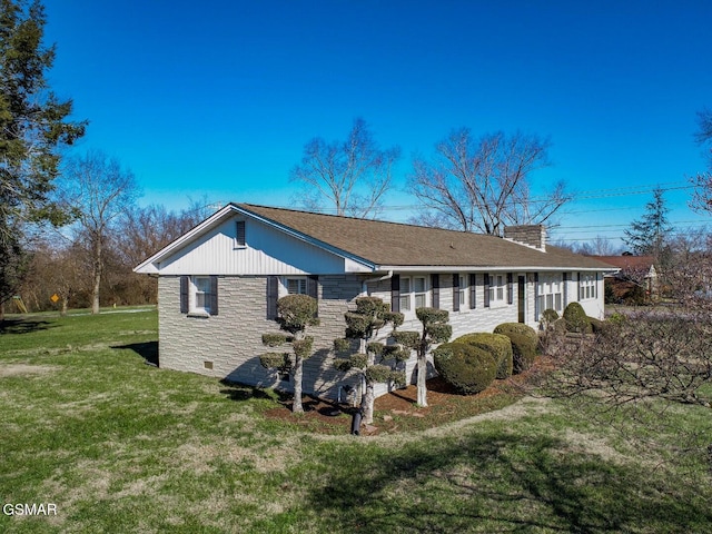 view of side of home with a yard