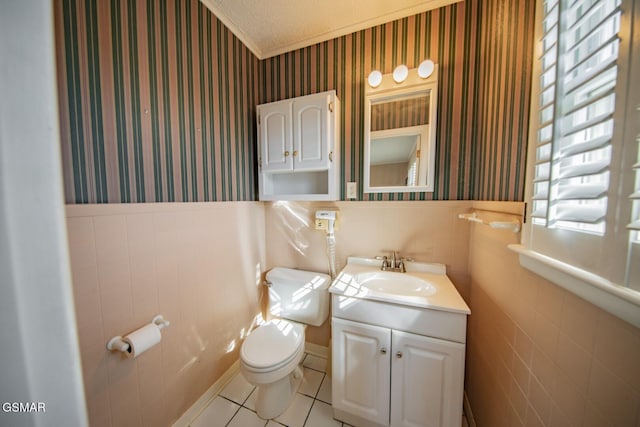 bathroom with a textured ceiling, toilet, vanity, and tile patterned flooring