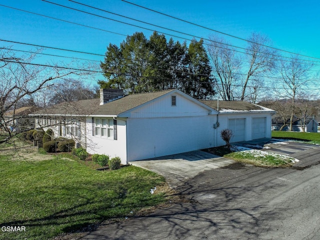 view of home's exterior featuring a garage and a yard