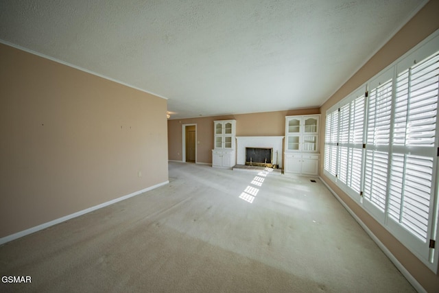 unfurnished living room with a textured ceiling and light colored carpet