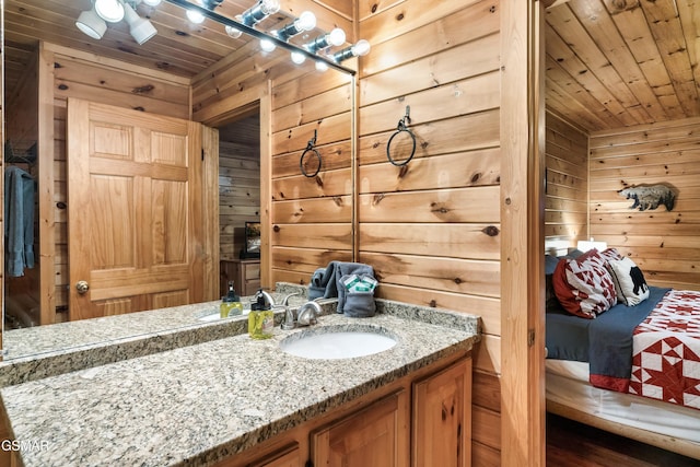 bathroom with vanity, wooden walls, and wooden ceiling