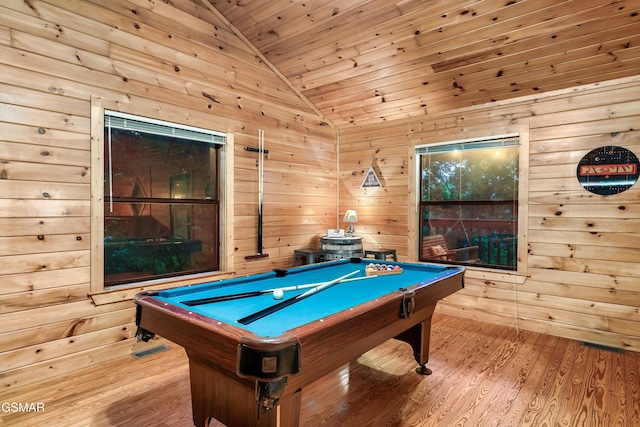 playroom with vaulted ceiling, light hardwood / wood-style flooring, and wood walls