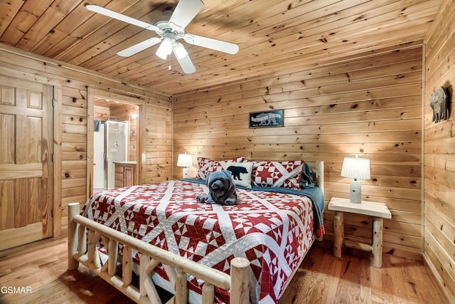 bedroom featuring wood ceiling, hardwood / wood-style floors, and wood walls