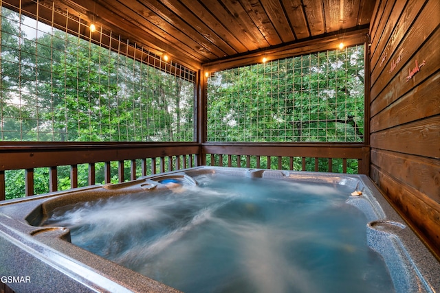 wooden deck with a hot tub