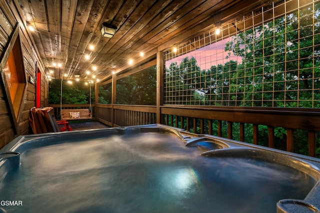 view of pool with a hot tub