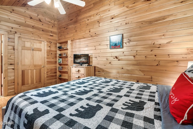 bedroom featuring vaulted ceiling, wooden walls, and ceiling fan