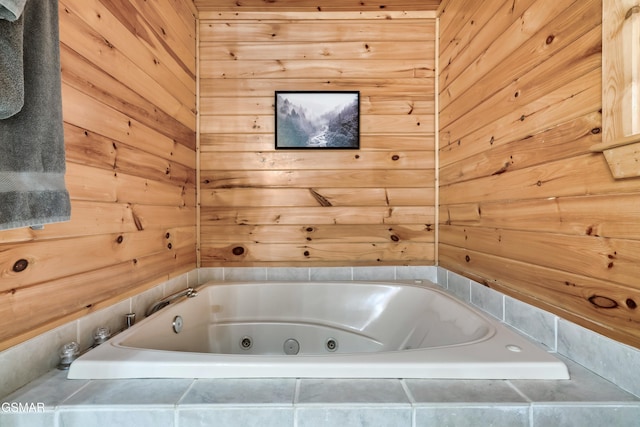 bathroom featuring a relaxing tiled tub and wood walls