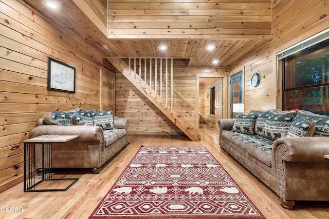 living room with light hardwood / wood-style flooring, wood ceiling, and wood walls