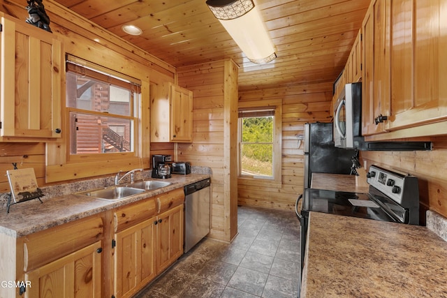 2326 Top Of The World Dr, Sevierville, TN 37876 - kitchen featuring stainless steel appliances, wood ceiling, wooden walls, light countertops, and light brown cabinetry