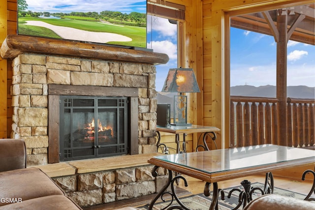 2326 Top Of The World Dr, Sevierville, TN 37876 - living room with a mountain view, an outdoor stone fireplace, and wood walls