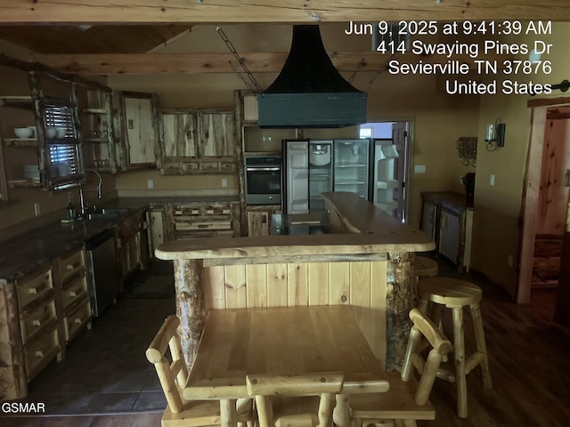 414 Swaying Pines Dr, Sevierville, TN 37876 - kitchen with appliances with stainless steel finishes, a kitchen island, and beam ceiling