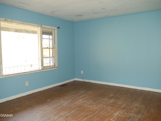 unfurnished room featuring dark hardwood / wood-style flooring