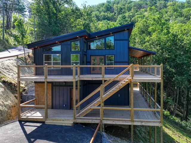 back of house with a wooden deck