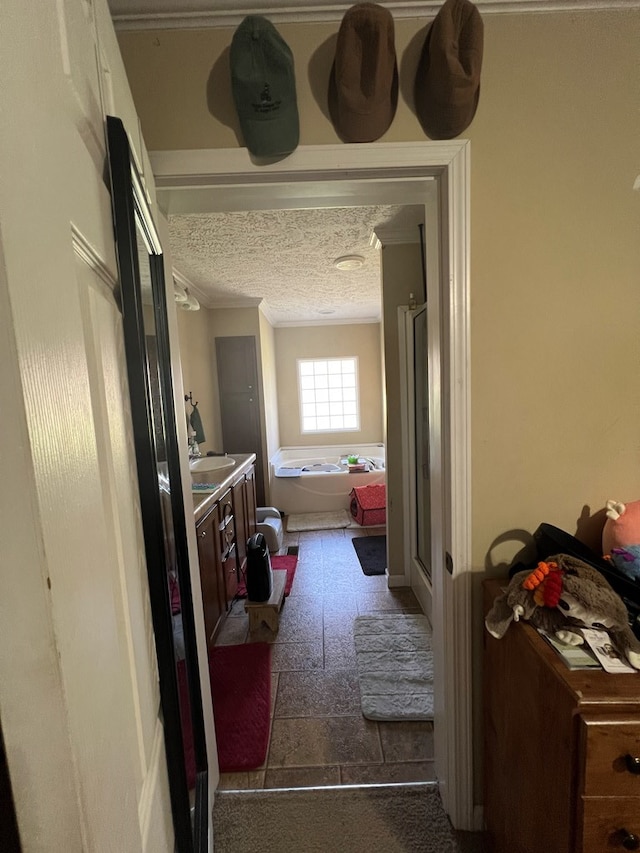 bathroom with separate shower and tub, vanity, and a textured ceiling