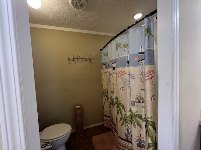 bathroom featuring tile patterned floors, a textured ceiling, and toilet