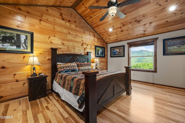 bedroom with baseboards, light wood-style floors, wooden ceiling, and vaulted ceiling