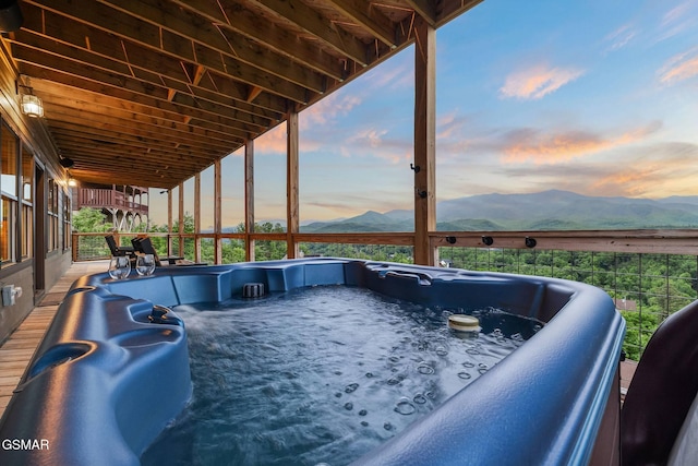 exterior space featuring a mountain view and a hot tub