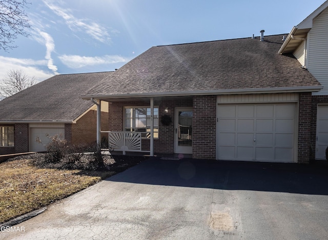 view of front of house featuring a porch and a garage