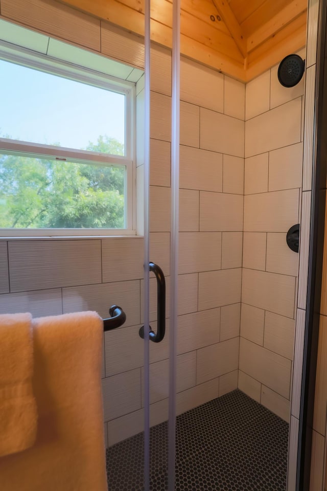 bathroom featuring a shower with door