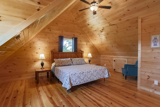 bedroom featuring ceiling fan, vaulted ceiling with beams, wooden walls, wood ceiling, and light wood-type flooring