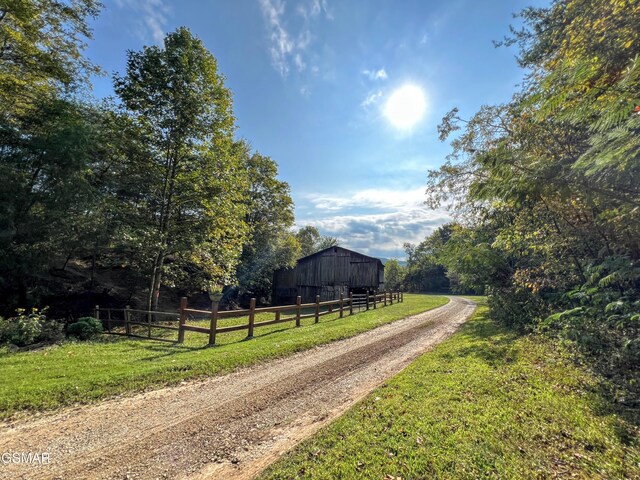1642 Little Cove Rd, Sevierville, TN 37862 - view of pole building featuring a forest view and a lawn