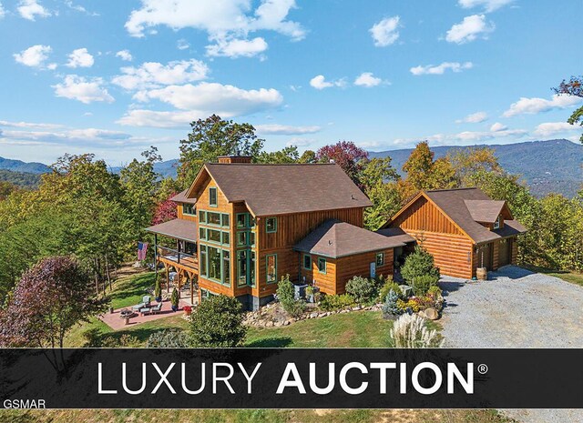 1642 Little Cove Rd, Sevierville, TN 37862 - back of property featuring a patio, a chimney, a yard, and a wooden deck