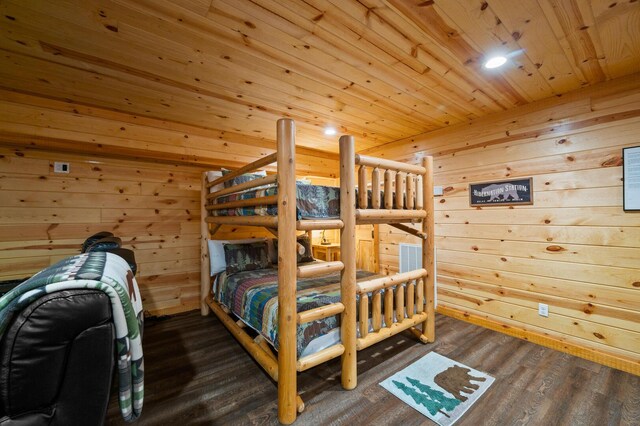 bedroom featuring wood ceiling, dark wood finished floors, and wood walls