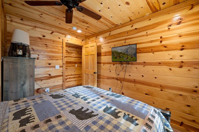 unfurnished bedroom featuring wood ceiling and wood walls