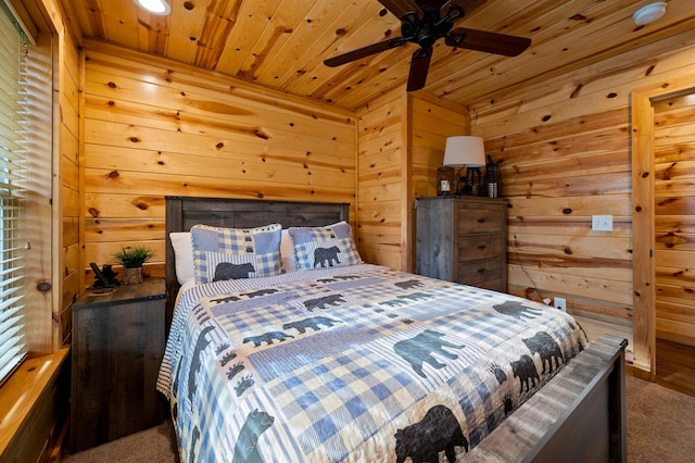 bedroom featuring wooden walls, wood ceiling, and carpet flooring