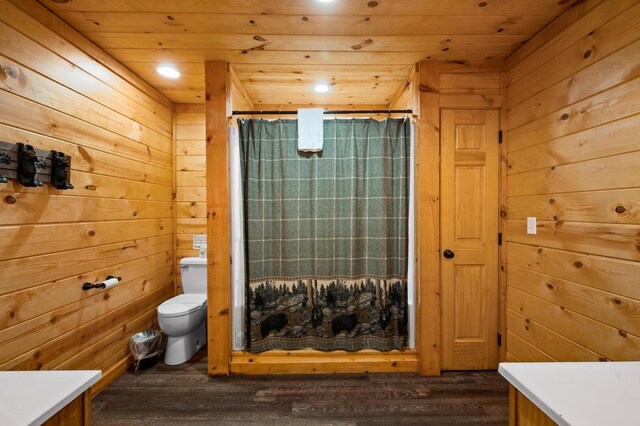 bathroom featuring a shower with shower curtain, toilet, wood ceiling, and wood walls