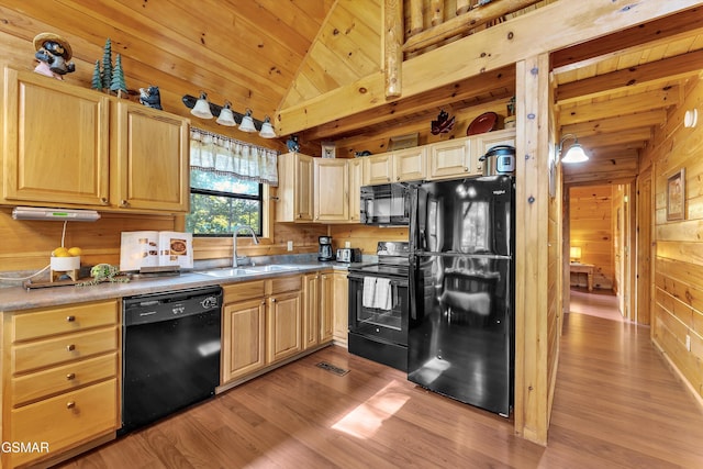 1926 Bird Hill Rd, Sevierville, TN 37876 - kitchen with black appliances, a sink, light wood-type flooring, wooden walls, and light brown cabinets