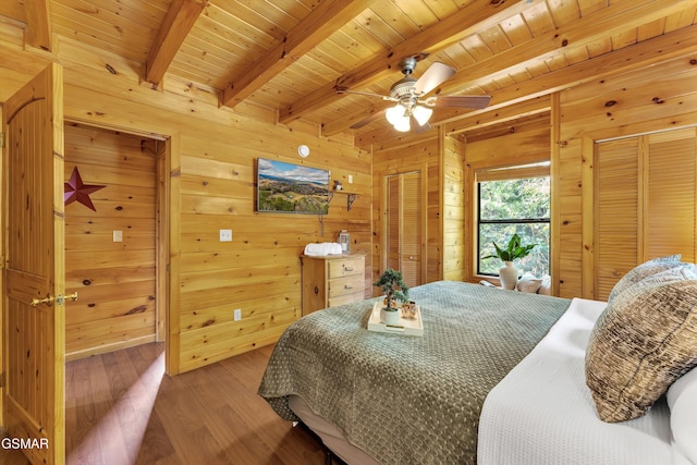 1926 Bird Hill Rd, Sevierville, TN 37876 - bedroom featuring two closets, beam ceiling, wood finished floors, wooden walls, and wood ceiling