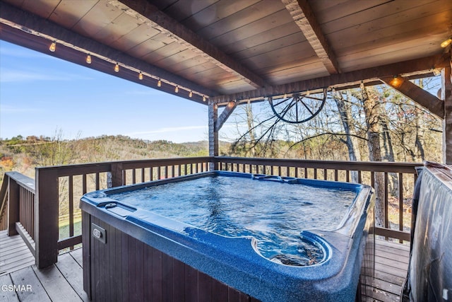 wooden terrace with a hot tub