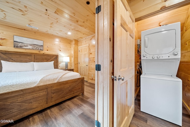 2939 Fiddlers Creek Way, Pigeon Forge, TN 37863 - bedroom with stacked washer and clothes dryer, wood walls, wood finished floors, and wood ceiling