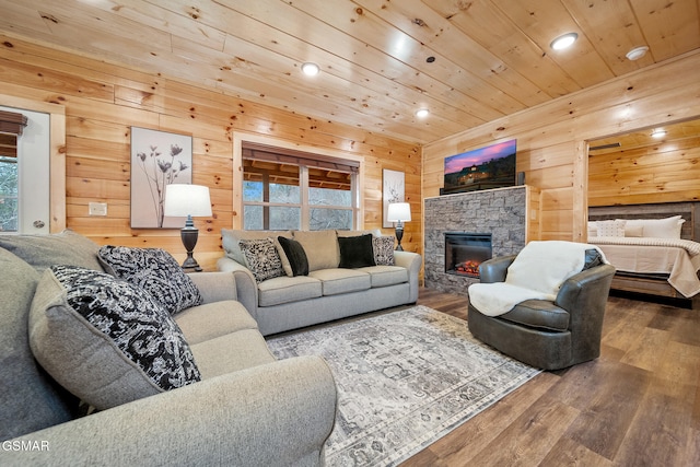 2939 Fiddlers Creek Way, Pigeon Forge, TN 37863 - living area with wooden walls, wood finished floors, recessed lighting, wooden ceiling, and a stone fireplace