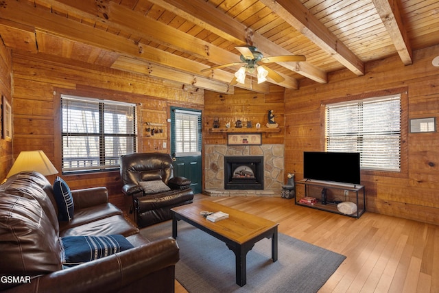 living room featuring beamed ceiling, wood walls, wooden ceiling, and wood-type flooring