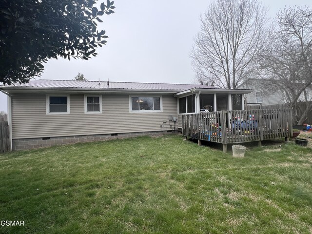 back of house featuring a wooden deck, crawl space, a yard, and metal roof