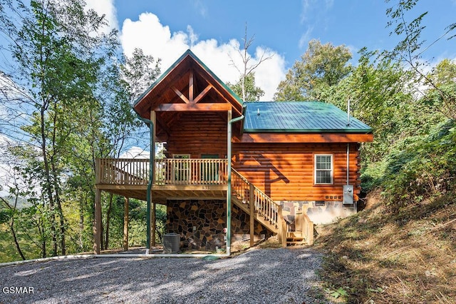 rear view of property featuring a deck and central AC