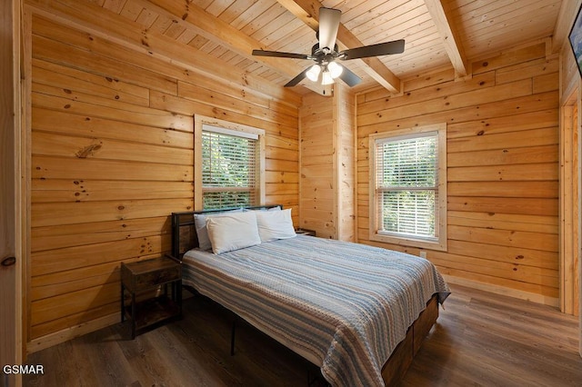 bedroom featuring multiple windows, wooden walls, beamed ceiling, and wood ceiling