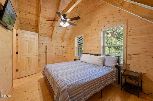 bedroom featuring wood walls, beam ceiling, wooden ceiling, and light hardwood / wood-style flooring