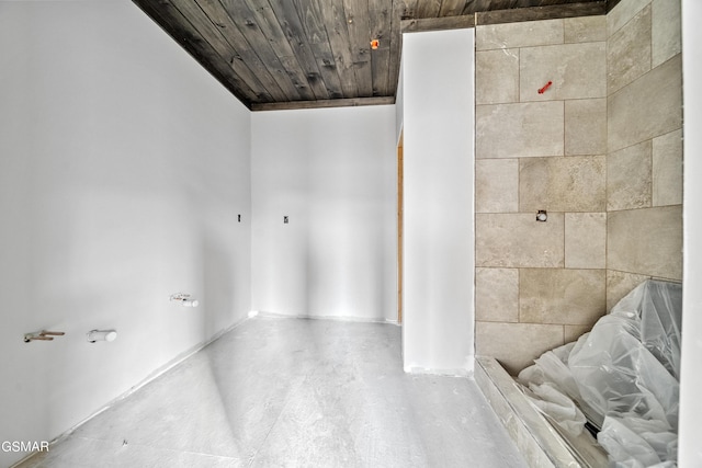 bathroom with wooden ceiling and concrete floors