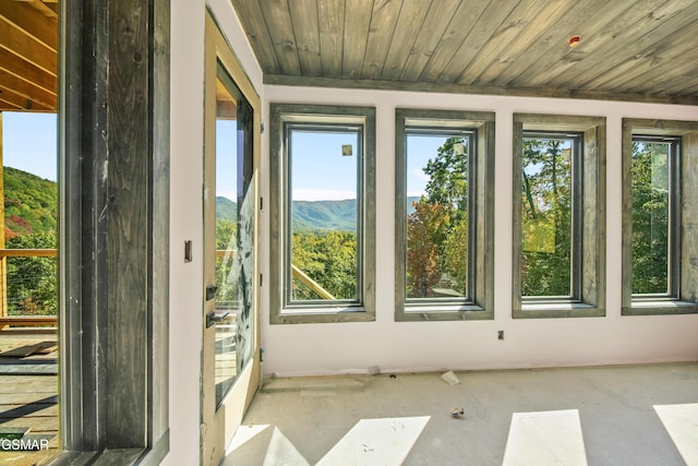 unfurnished sunroom featuring a mountain view