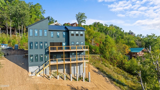 back of house featuring a wooden deck