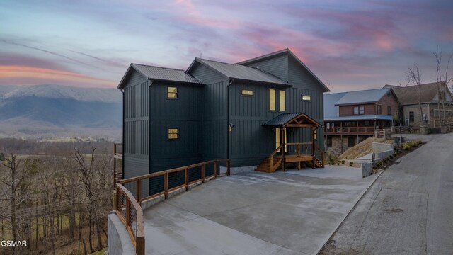 view of front of house featuring metal roof, board and batten siding, and a mountain view