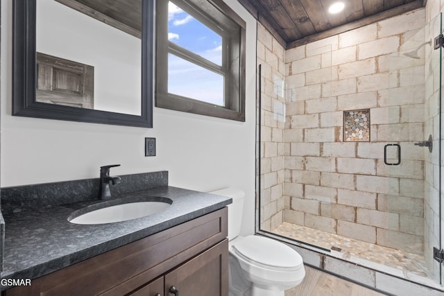 bathroom with vanity, a shower stall, toilet, and wood ceiling