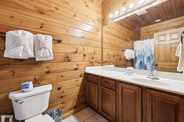 bathroom featuring toilet, wooden walls, tile patterned floors, a shower with curtain, and vanity