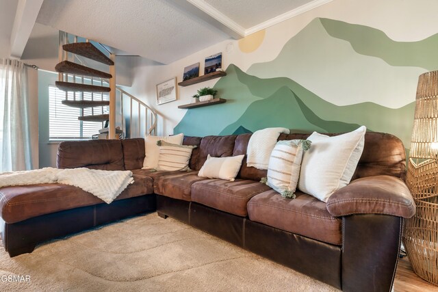 living room with beam ceiling, light hardwood / wood-style floors, ornamental molding, and a textured ceiling