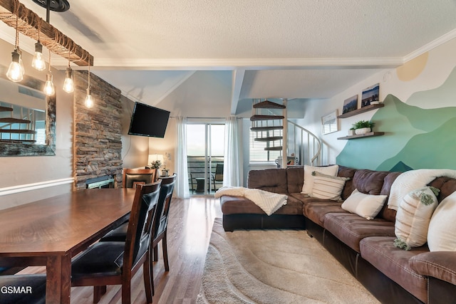 living room with hardwood / wood-style floors, crown molding, and a textured ceiling