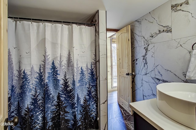 1125 Tanrac Trl, Gatlinburg, TN 37738 - bathroom featuring a shower with shower curtain, tile walls, marble finish floor, and vanity